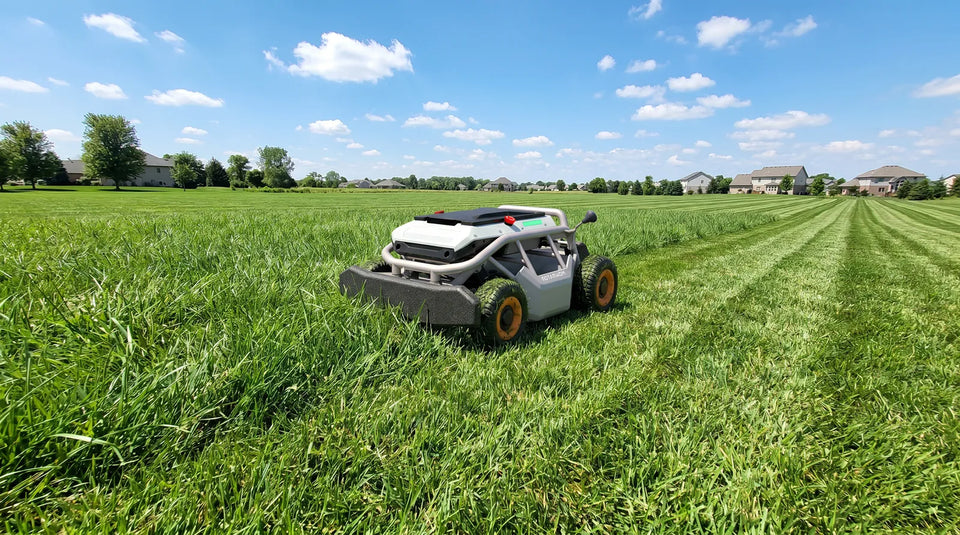 Mowrator S1 remote control lawn mower cutting a large residential lawn with clean mowing stripes